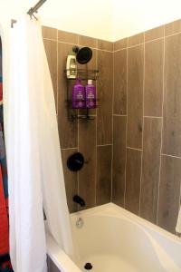 a bathroom with a shower with a tub at The Barn House in Eureka Springs