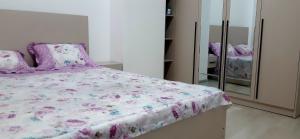 a bedroom with a bed and a mirror at City Center Apartment "Afsona mall" in Irvadan +10 photos