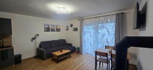 uma sala de estar com um sofá e uma mesa em Pension Martinské údolí em Kořenov