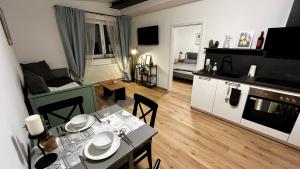 a living room with a dining table and a living room at Wohlfühlwohnung mit Dachterrasse in Donaueschingen
