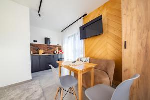 a kitchen and dining room with a table and chairs at ApartRoom 18 in Zakopane