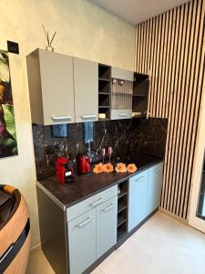 a kitchen with blue cabinets and a black counter top at Aura Spa Herne Premium in Herne