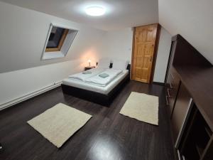 a bedroom with a bed and a dresser and a door at Gyékény Pihenő in Szarvas