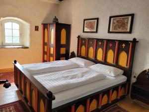 a bedroom with a large bed in a room at Burg Liebenstein in Kamp-Bornhofen