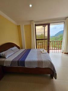 a bedroom with a bed with a view of a balcony at Puente de Gocta in Cocachimba +107 photos