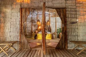 a room with a table and a mirror in a room at Ipuana Virgin Beach in Manaure