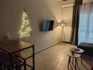 a living room with a christmas tree on the wall at Katerina's apartment in Serres