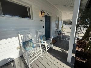 a porch with two rocking chairs on a house at The Elizabeth Suite in Key West