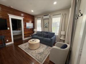 a living room with a blue couch and a table at The Elizabeth Suite in Key West