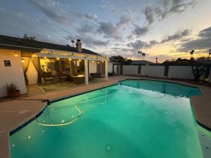 a large swimming pool in front of a house at Pool paradise near ASU campus & Scottsdale in Tempe +43 photos