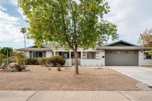 a tree in front of a house with a garage at Pool paradise near ASU campus & Scottsdale in Tempe