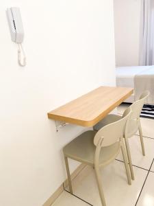 a wooden table and two chairs in a room at Apto Compacto Ótimo Custo-Benefício in Guaíra