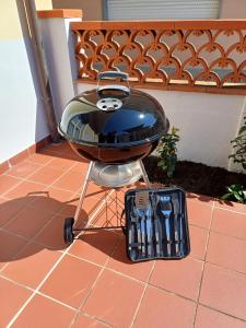 a bbq grill sitting on the ground with a basket at Casa Le Camelie in Stiava