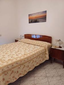 a bedroom with a bed and a table with a night stand at Casa Le Camelie in Stiava