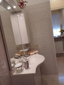 a bathroom with a white sink and a mirror at Casa Le Camelie in Stiava +23 photos