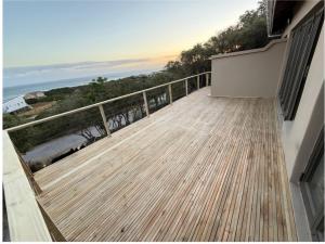a balcony with a view of the ocean at Seenekal views in Cannon Rocks +4 photos