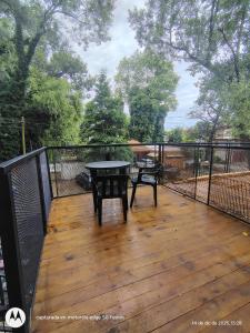 a wooden deck with a table and chairs on it at Large Duplex #1 in San Bernardo +14 photos