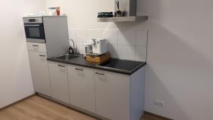 a small kitchen with a sink and a refrigerator at Lely in Lelystad