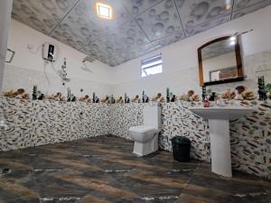 a bathroom with a toilet and a sink at Kavidi Villa Home Stay in Tangalle