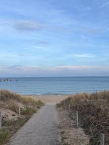 a path to the beach with the ocean in the background at Ferienwohnung Haus Rügen in Göhren