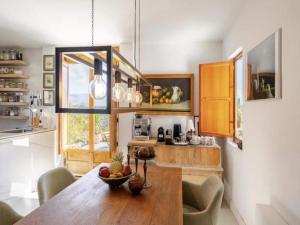 a dining room with a wooden table in a kitchen at 5-Bedroom Villa with Pool, Swimjet and Jacuzzi in Comares