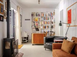 a living room with a couch and a book shelf at 5-Bedroom Villa with Pool, Swimjet and Jacuzzi in Comares