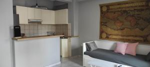 a kitchen with a couch with a map on the wall at Parastaseis City Apartment Central in Patra