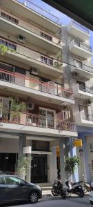 an apartment building with motorcycles parked in front of it at Parastaseis City Apartment Central in Patra