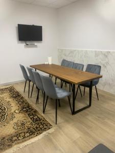 a dining room with a wooden table and chairs at Будинок з чаном in Druzhba