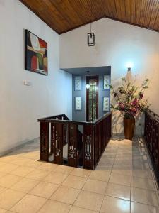 a room with a table and a vase of flowers at Rumanga Residence in Angoda