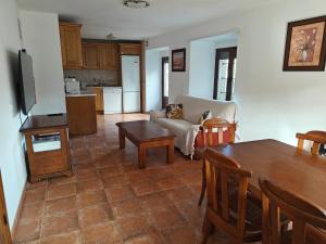 a living room with a table and a couch at El Locutorio in San Martín de la Vega del Alberche +6 photos
