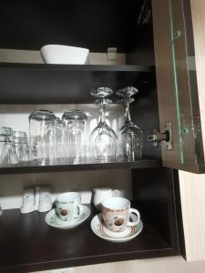 a shelf with two cups and glasses on it at Bella Apartment in Ruse +34 photos