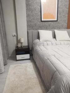 Postel nebo postele na pokoji v ubytování Bella Apartment