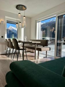 a dining room with a table and chairs and mountains at MOUNTAIN HOME apartment in Finkenberg