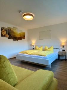 a bedroom with a large bed and a couch at MOUNTAIN HOME apartment in Finkenberg