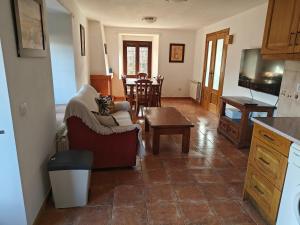 a living room with a couch and a table at El Locutorio in San Martín de la Vega del Alberche