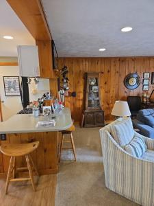 a living room with a table and a couch at Against the Wind Vacation Rental LLC in Lake Leelanau