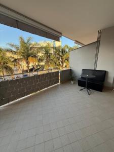 a balcony with a table and a wall with palm trees at Rama house in Caserta