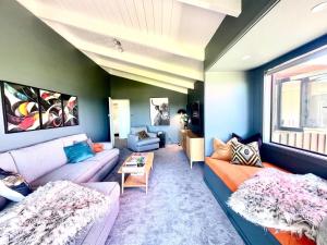 a living room with a couch and a table at Iconic Taupō Views in Taupo