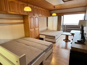 a room with two beds and a table and a desk at Kulmhof in Tauplitz