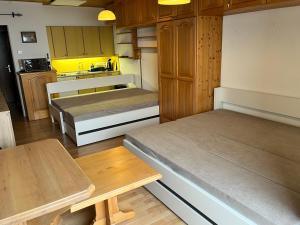 a small kitchen with two beds and a table at Kulmhof in Tauplitz +17 photos