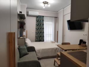 a small room with a bed and a window at Parastaseis Central Studio Georges Sq in Patra