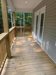 a front porch of a house with a wooden deck at Modern Nature Escape in Sparta