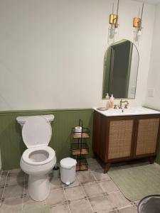 a bathroom with a toilet and a sink and a mirror at Modern Nature Escape in Sparta +16 photos