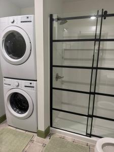 a washer and dryer next to a washing machine at Modern Nature Escape in Sparta