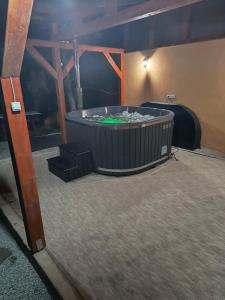 a room with a hot tub in the middle of a room at PENSIUNEA KELEMEN in Praid
