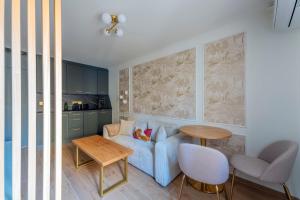 a living room with a blue couch and a table at Spa & Relaxation 15 min de Lyon - Noomi Suite in Oullins +17 photos