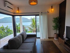a living room with a couch and a large window at T2 moderne en bord de mer 