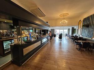 a restaurant with a bar and tables and chairs at The Royal Oak Hotel in Ramsgate