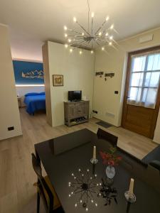 Il Boschetto della Valle Maira في Villar San Costanzo: غرفة معيشة مع طاولة طعام وثريا +16 صورة